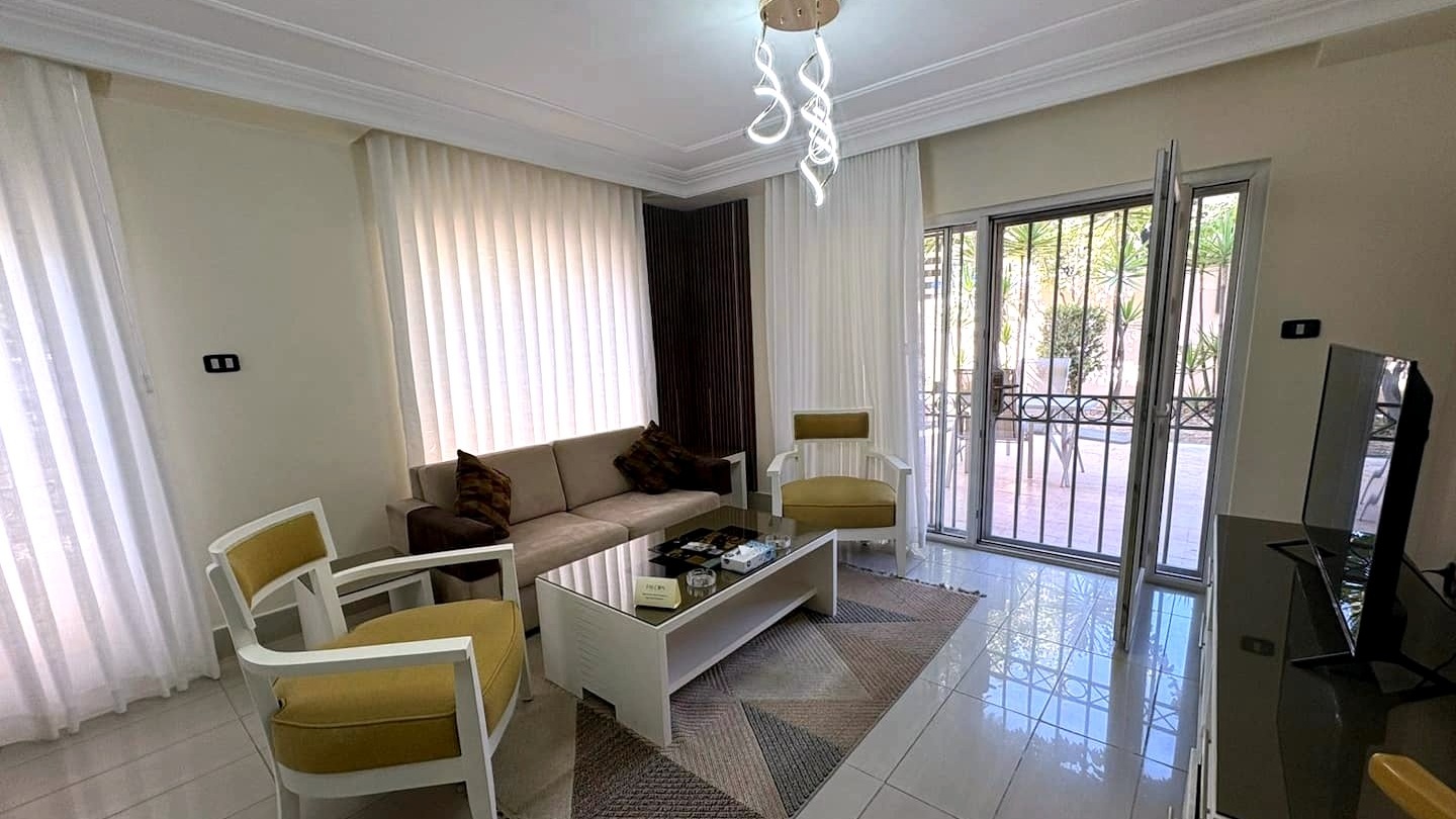 The Garden apartment's living room, door open to the patio